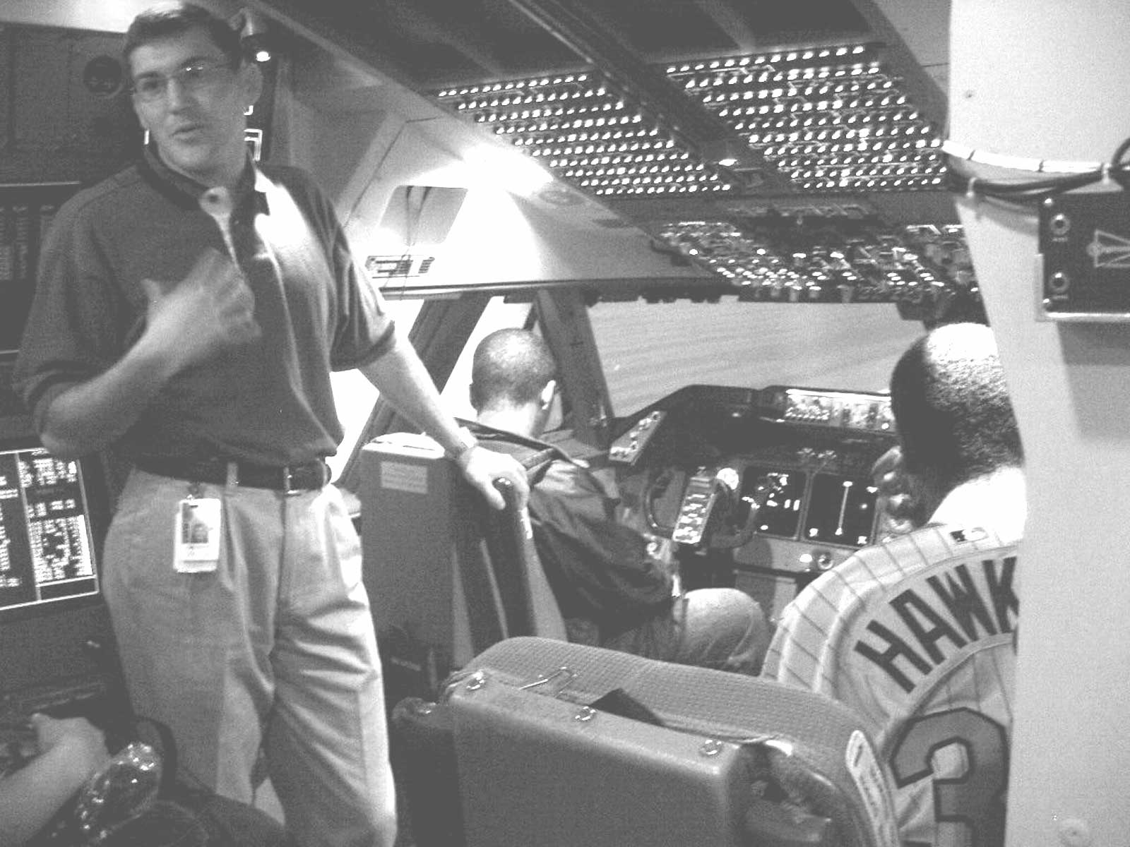 NWA employee demonstrates a flight simulator to students with disabilities.